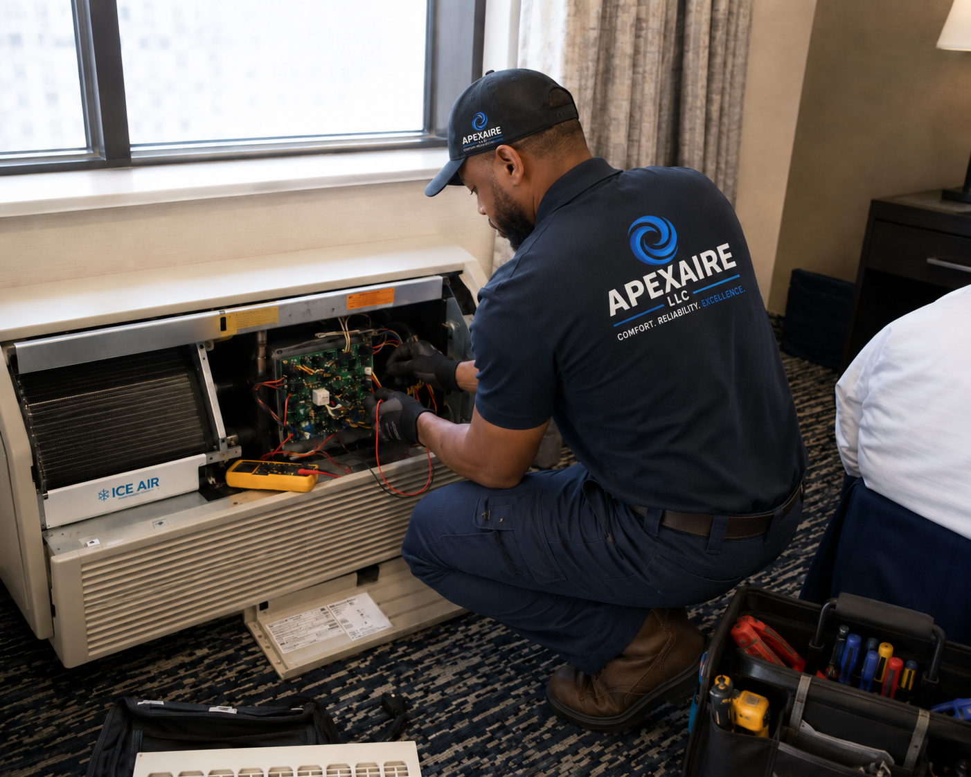 APEXAIRE technician servicing an Ice Air PTAC unit
